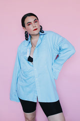 Men's vintage 1970's After Six Accessories label long sleeve blue colored tuxedo shirt with front chest ruffles. Openings for cuff links and studs.