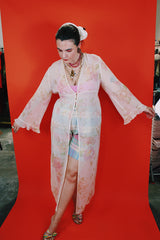 Women's vintage 1980's Valerie Stevens label long sleeve cream sheer lingerie robe with pink floral print, ruffle sleeves, and a tree button closure.