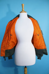 Women's or men's vintage army bomber jacket. Cropped and reversible in a Nylon material. One side is army green and one side in orange.