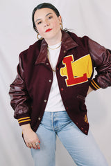 Men's or women's vintage 1980's Settlemien's label long sleeve maroon varsity letterman jacket with a yellow patch and trim.