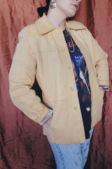 Women's or men's vintage 1970's Styled by Scully in Los Angeles long sleeve long length tan camel colored leather jacket with leather buttons up the front.