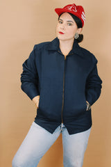 Men's or women's vintage 1970's Unitog Company, Union Made in USA label size large long sleeve navy blue station jacket that zips up the front with red nylon liner.