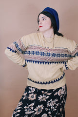 Women's or men's vintage 1980's size large long sleeve tan colored pullover sweater in an acrylic material. Navy and maroon print.