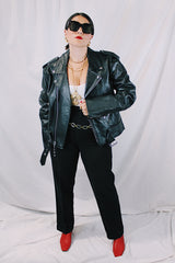 Men's vintage 1980's black genuine leather zip up motorcycle style jacket. All over silver hardware, popper buttons, and and zippers.