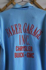 Men's or women's vintage 1970's short sleeve baby blue polyester material polo shirt with half button closure and red glittery wording on the back