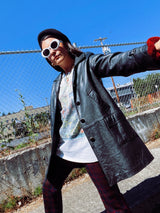 long sleeve black long leather jacket, collar and buttons up the front vintage 1960's