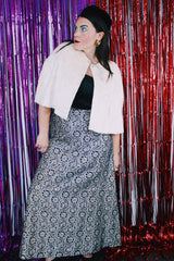 Women's vintage 1970's maxi length navy blue skirt. Skirt has an all over silver and gold embroidered metallic pattern.