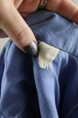 Men's vintage 1970's long sleeve button up blue colored shirt with patchwork detail throughout. Pearl snapper buttons up the front.