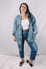 Men's or women's vintage 1980's Levi's medium wash denim lightweight jacket with brass hardware. Buttons up the front and four pockets. Size XXL.