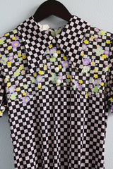 Women's vintage 1970's short sleeve puff sleeve bodysuit with collar in a black and purple checkered print and florals.