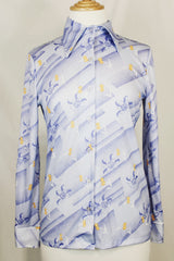 Women's vintage 1970's Devon long sleeve button up blouse with a dagger collar. Light purple color with all over ditsy floral print.