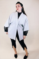 Women's vintage 1960's long sleeve textured kimono. Baby blue color with blue and white floral liner. Ties in the front. Wide big sleeves.