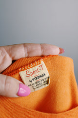 Women's or men's vintage 1970's Sport-T by Stedman label short sleeve orange tee with white graphic on the front and back in a cotton and polyester material.