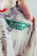 Women's or men's vintage 1970's Scene 3 by Da Vinci label long sleeve slinky polyester material button up shirt with a novelty print in white, grey, and light pink.