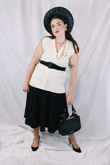 Women's vintage 1970's Montgomery Ward sleeveless button up sweater vest cardigan in a cream white color. Acrylic material and all over cable knit texture.