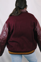 Men's or women's vintage 1980's Settlemien's label long sleeve maroon varsity letterman jacket with a yellow patch and trim.
