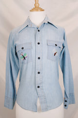 Men's or women's vintage 1970's JCPenney label long sleeve light blue chambray denim shirt with all over colored embroidery.