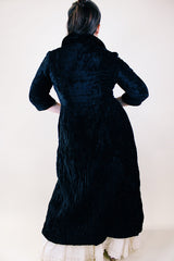 Women's vintage 1960's Raymodes, NY label long length long sleeve black velvet duster coat. Bronze buttons with bronze chains.