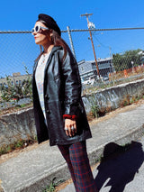 long sleeve black long leather jacket, collar and buttons up the front vintage 1960's