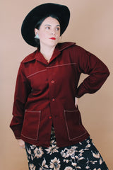Women's or men'd vintage 1970's size medium long sleeve maroon color button up lightweight western style jacket with pockets and contrast stitching.