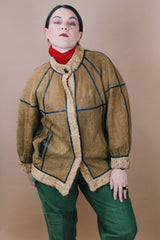 Women's vintage 1970's size medium long sleeve tan brown suede jacket with one button closure, cream fur trim, and black trim throughout.