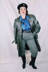 Men's or women's vintage 1970's Made in Argentina label knee length dark grey colored leather trench coat with double lapel and button closure.