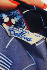 Men's vintage 1970's Da Vinci Presents Delfina label long sleeve vibrant navy blue button up shirt with all over white and red abstract print in thick polyester material.