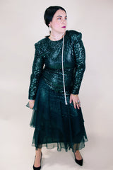 Women's vintage 1980's long sleeve ankle length dress with all over sequins and a tiered ruffles skirt. Forest green color.