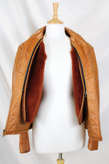 Men's or women's vintage 1970's The Leather Shop, Sears The Men's Store label long sleeve short length camel brown colored leather zip up jacket.