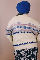 Women's or men's vintage 1980's size large long sleeve tan colored pullover sweater in an acrylic material. Navy and maroon print.