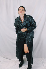 Men's or women's vintage 1980's Vakko Sport, Made in USA label long sleeve long length black leather trench coat. Double breasted closure, shoulder pads, and matching tie belt.