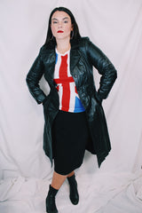 Women's vintage 1970's knee length long sleeve black leather trench coat with double lapel and button front closure.