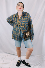 Men's or women's vintage 1970's JCPenney label long sleeve button up shirt with dagger collar in a polyester material. Brown color with all over blue print.