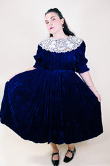 Women's vintage 1970's crushed blue velvet dress with cream embroidery peter pan collar. Short sleeves and ankle length.