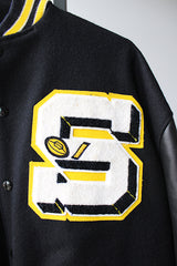 Men's or women's vintage 2000's Settlemein's, Portland, Oregon label long sleeve black varsity letterman jacket with yellow trim.