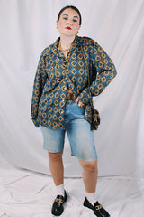 Men's or women's vintage 1970's JCPenney label long sleeve button up shirt with dagger collar in a polyester material. Brown color with all over blue print.