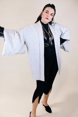 Women's vintage 1960's long sleeve textured kimono. Baby blue color with blue and white floral liner. Ties in the front. Wide big sleeves.