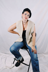 Men's or women's vintage 1970's Norsewear, Made in New Zealand label sleeveless zip up wool material vest in an oatmeal cream color. Ribbed texture all over.