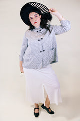 Women's vintage 1960's The Original Stork-A-Lure label long sleeve grey stain jacket with all over print. Black buttons up the front and mandarin collar.