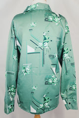 Men's vintage 1970's Don Giovanni California label long sleeve green colored button up shirt with all over floral print in a thick polyester material.