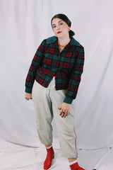 Women's vintage 1960's Pendleton label long sleeve plaid print wool cropped lightweight jacket in red and green colors. Fully lined, buttons up the front, and two front pockets.