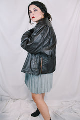 Men's or women's vintage 1980's Kirk's Suede Life label long sleeve oversized dark chocolate brown leather bomber jacket with zipper front closure.