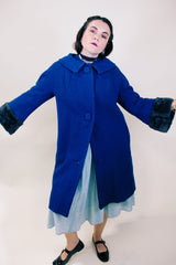 Women's vintage 1960's Jack Bloom California label long sleeve royal blue color coat. Ankle length with grey fur trim around collar and cuffs.