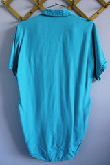 Men's or women's vintage 1970's The Swingster label short sleeve bright blue button up bowling shirt with chest pockets and name embroidered near pocket.