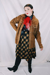 Men's or women's vintage 1970's long sleeve light brown tan colored suede jacket. Has silver snap buttons, contrast stitching, and a dagger collar.