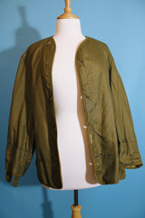 Men's or women's vintage 1950's long sleeve reversible army liner jacket. One side is a nubby cream color and one side is green Nylon.
