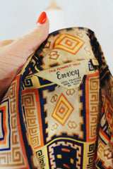 Men's vintage 1970's Envoy label long sleeve button up shirt with dagger collar with all over orange and navy abstract print.