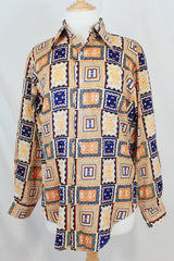 Men's vintage 1970's Envoy label long sleeve button up shirt with dagger collar with all over orange and navy abstract print.