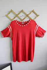 Women's or men's vintage 1970's Post label short sleeve red sports top with white stripes on arms, red and white trim, and white graphic with words on the back.