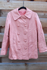 Women's vintage 1970's peach pink colored leather double breasted pea coat. Double lapel, pockets, and fully lined.